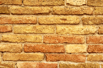 weathered yellow and red brick wall