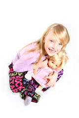 Portrait of cute smiling little girl with a doll sitting isolate