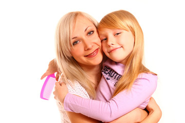 Hugging mother and daughter with a comb isolated on white backgr