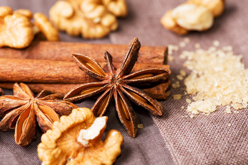 Star anise walnut brown sugar with cinnamon on cloth background