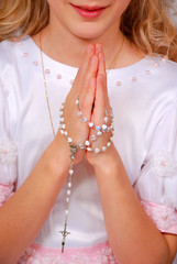 girl praying in day of the first holy communion