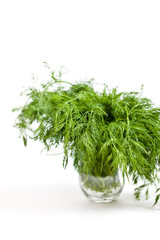 Glass with dill on white background