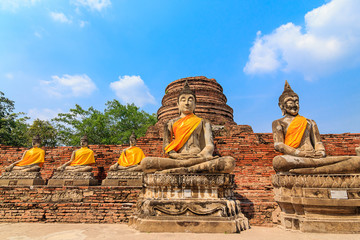 Fototapeta na wymiar Ancient Buddha statues at Wat Yai Chai Mongkol in Ayutthaya, Tha