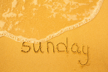 Sunday - written in sand on beach texture(days week series)