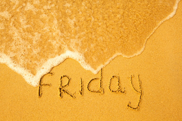 Fototapeta premium Friday - written in sand on beach texture(days week series)
