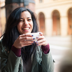 Young woman drinking coffee in a cafe outdoors. Shallow depth of - 49737598
