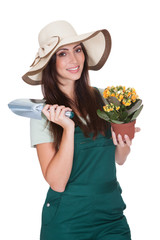 Pretty Woman Holding Plant And Gardening Shovel