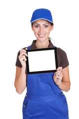Smiling Female Plumber Holding Digital Tablet