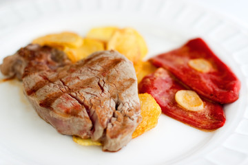 Sirloin steak with fries and red peppers