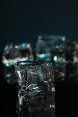 Ice cubes on dark blue background