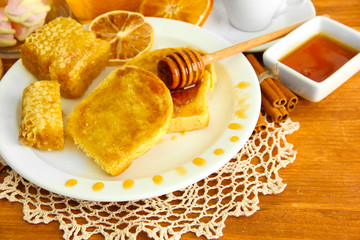 White bread toast with honey and cup of coffee on wooden table