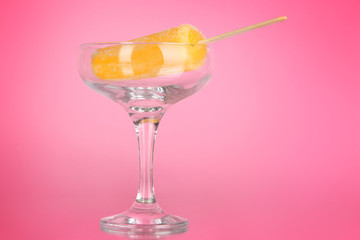Yellow fruit juice ice in vase on pink background