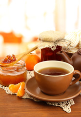 light breakfast with tea and homemade jam, on wooden table