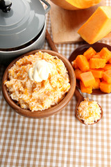 Taste rice porridge with pumpkin in bowl