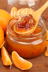 tasty homemade mandarine jam, on wooden table
