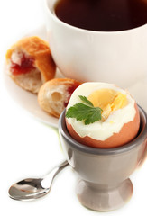 Light breakfast with boiled egg and cup of coffee, isolated