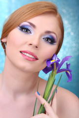 Beautiful young woman with glamour make up and flower
