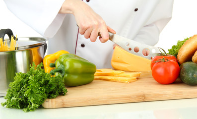 Female hands cutting cheese, isolated on white