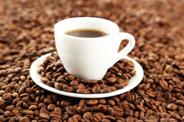 Cup of coffee on coffee beans background