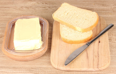 Bread with vegetable oil on wooden background