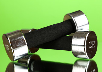 Dumbbells at 2 kg on green background