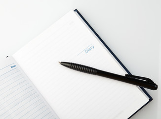 Open notebook with pen