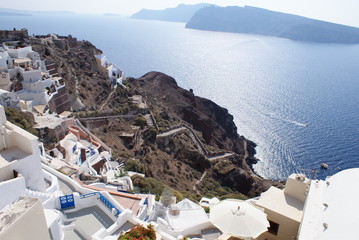 Old-style white traditional windmills in terraced village Oia