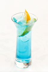blue cocktail with ice and lemon