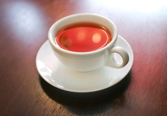 Cup of tea on wooden table, macro