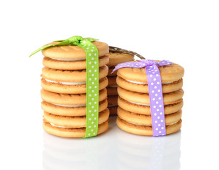 Cookies decorated with ribbons on white background