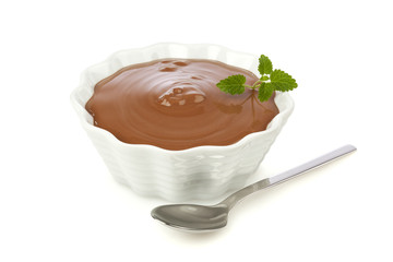 Chocolate dessert in a bowl with spoon isolated