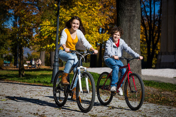 Urban biking - teens riding bikes in city