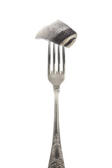 Piece of fish on silver fork isolated