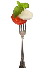Caprese salad on silver fork isolated