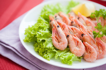 prawns on lettuce leaf on a white plate