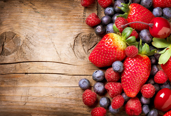 Berries on Wooden Background. Organic Berry over Wood