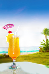 glass of fresh juice on sea background