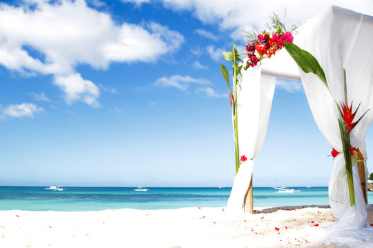 Wedding Arch Decarated With Flowers On Beach
