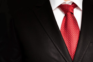 businessman in a black suit with a red tie