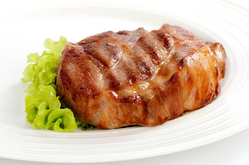 Grilled steak meat on a white plate