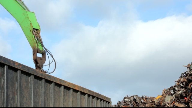 Crane grabber unload the truck with recycling steel