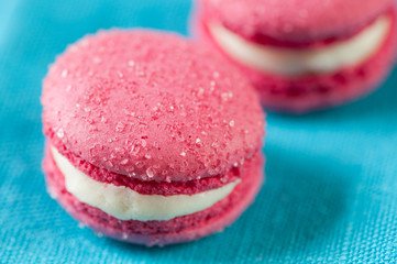 Close-up of vanilla flavoured macaroons on a turquoise serviette