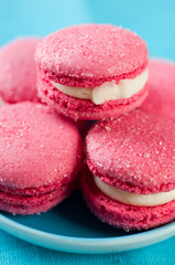 Stack of brightly coloured macaroons, close-up, studio shot
