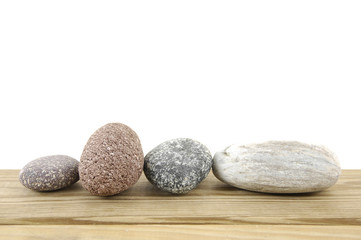 Several stones isolated over wood board