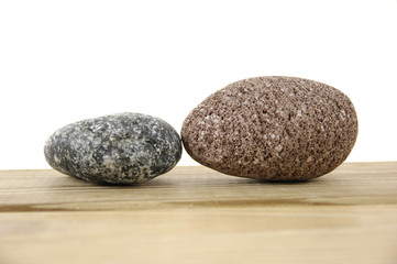 two rocks on a wood board