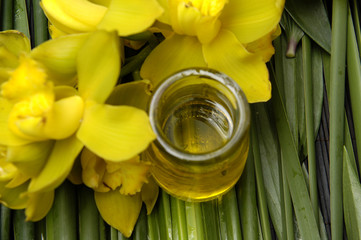oil bottles and yellow orchid on bamboo grove