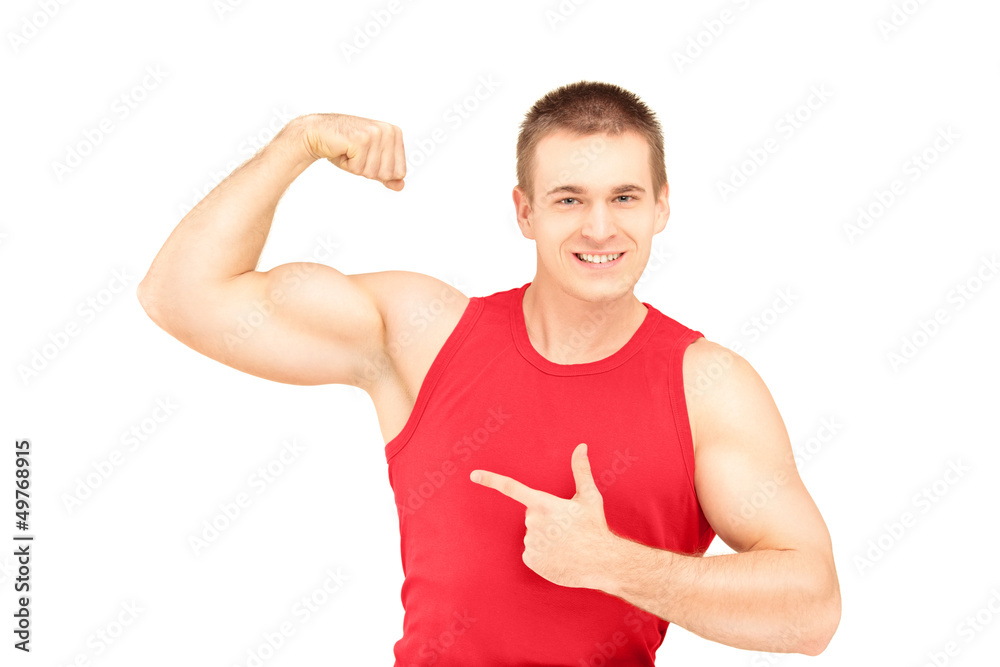 Wall mural muscular young man showing his biceps