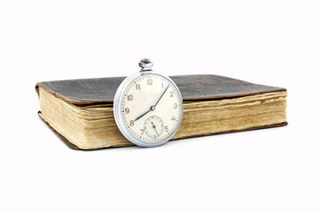 Vintage pocket watch and old book