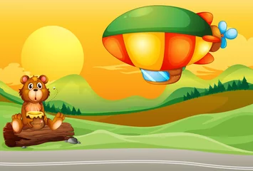 Zelfklevend Fotobehang Een beer bij de weg en een luchtschip © GraphicsRF