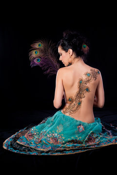 Peacock Feather Henna Design on a Woman’s Back